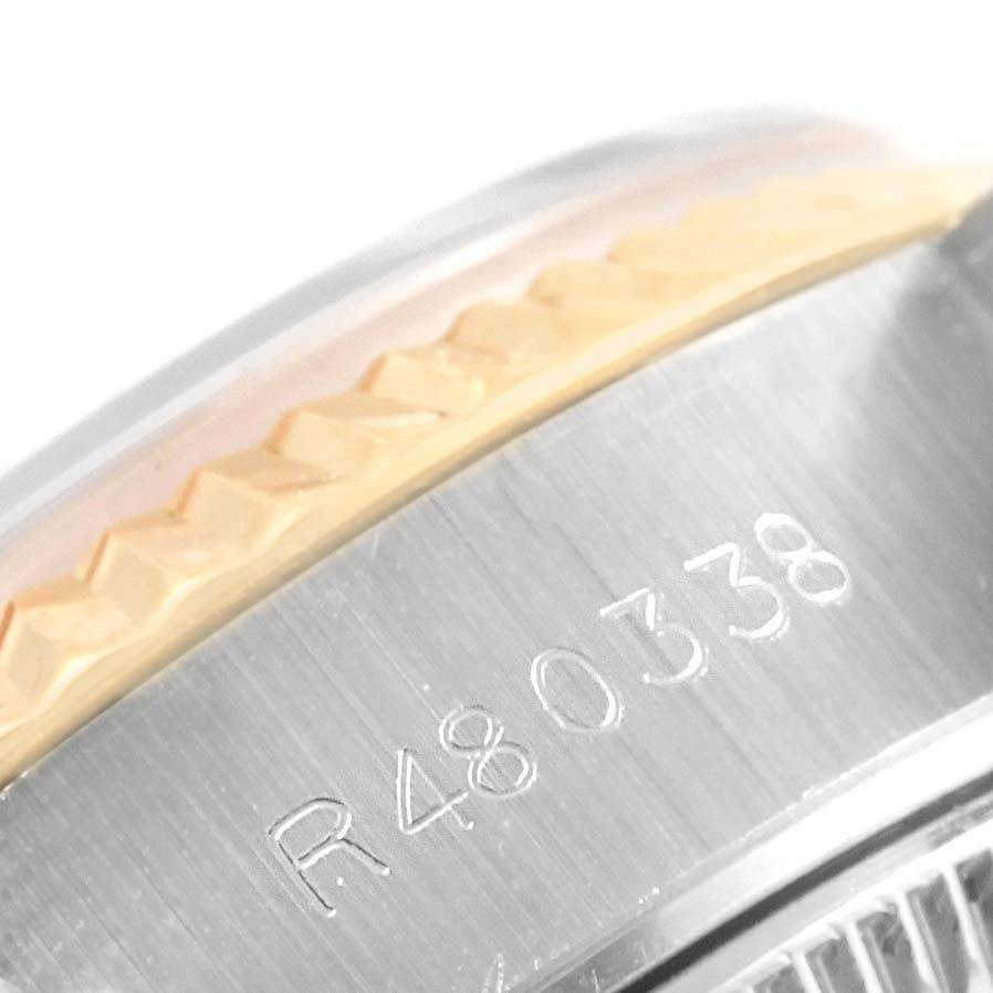 This close-up image of a Rolex Datejust 69173 Women's Stainless Steel Black Dial 69173 Women's Stainless Steel Black Dial watch shows the engraved serial number and partially visible bezel.