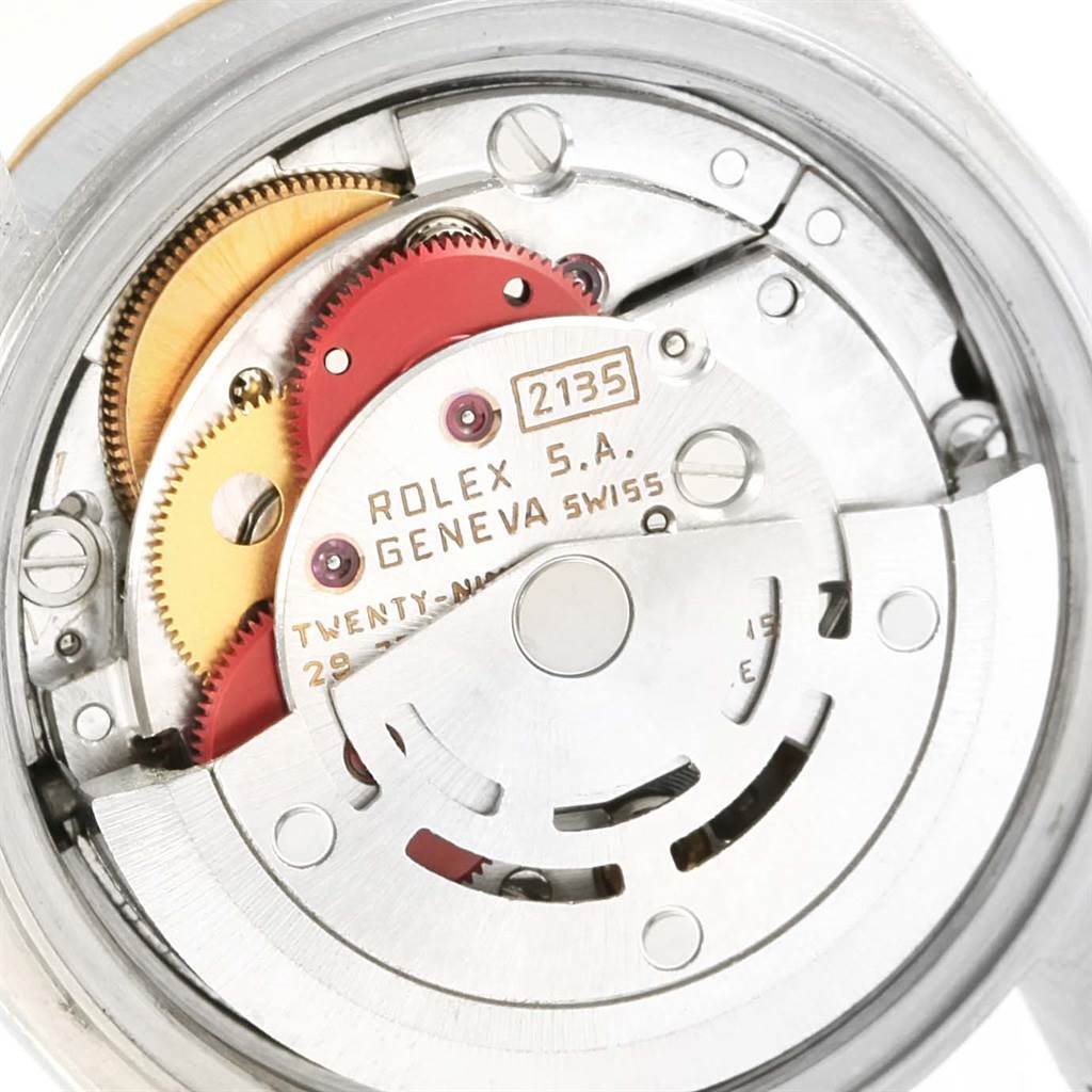 The image shows a close-up view of the internal movement mechanism of a Rolex Datejust 69173 Women's Stainless Steel Black Dial 69173 Women's Stainless Steel Black Dial watch, highlighting gears and components.