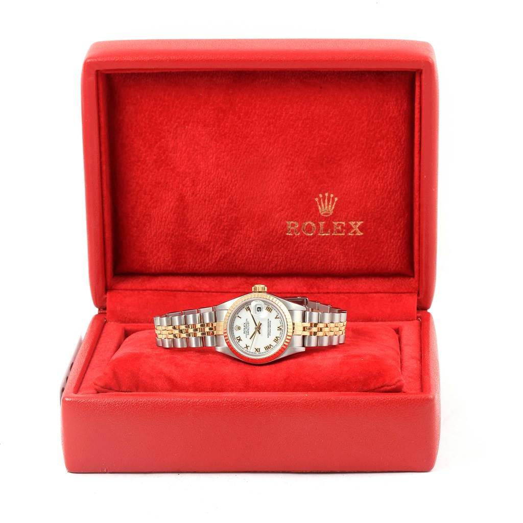 The Rolex Datejust 79173 Women's Steel and Gold (two tone) White Dial 79173 Women's Steel and Gold (two tone) White Dial watch is shown at a front angle, inside a red Rolex box.