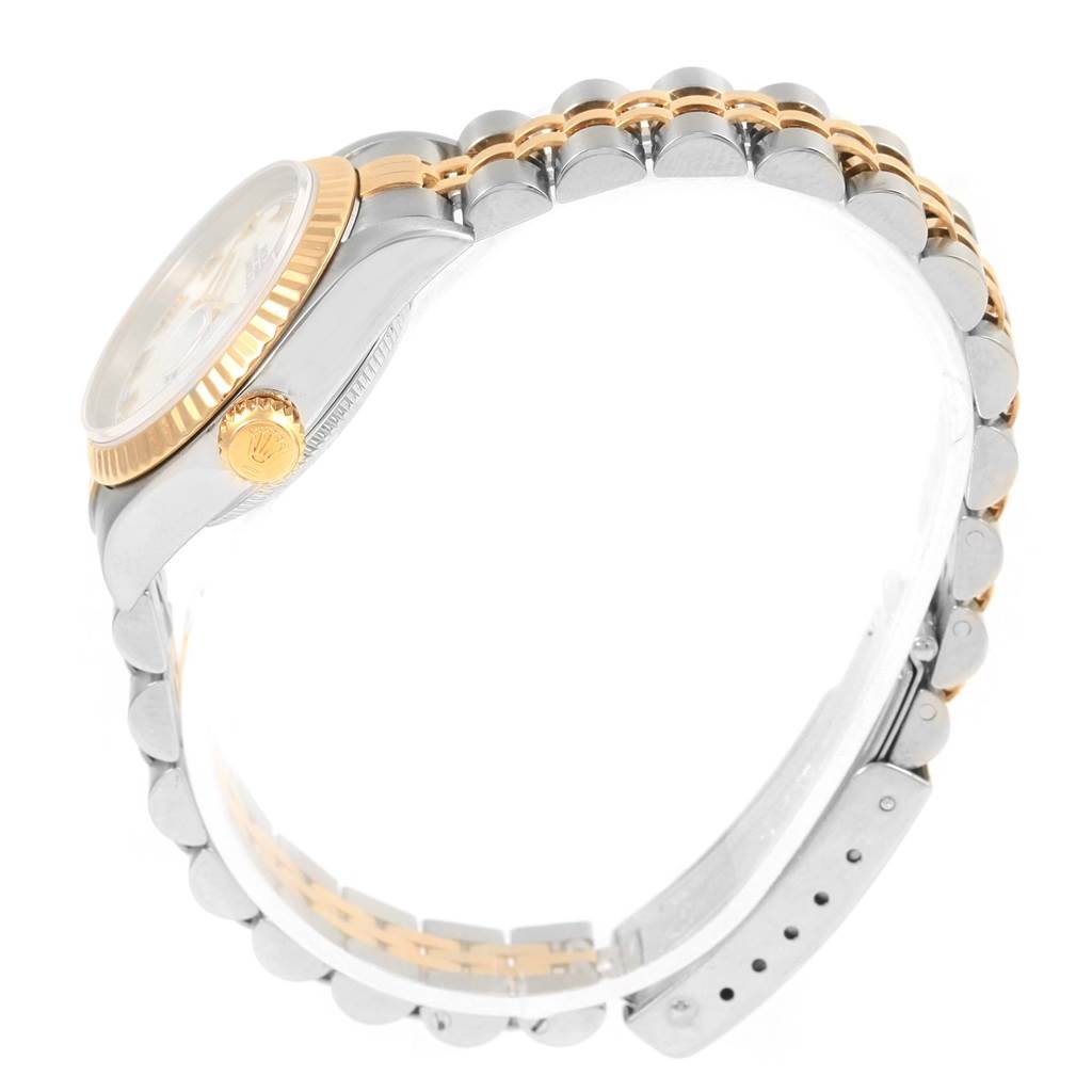 The Rolex Datejust 79173 Women's Steel and Gold (two tone) White Dial 79173 Women's Steel and Gold (two tone) White Dial watch is shown from a side angle, highlighting its two-tone bracelet, case, crown, and fluted bezel.