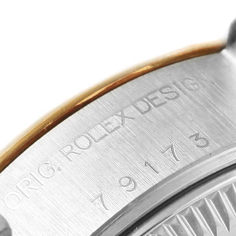 The image shows a partial close-up of the side of a Rolex Datejust 79173 Women's Steel and Gold (two tone) White Dial 79173 Women's Steel and Gold (two tone) White Dial watch case, highlighting the engraved serial number and "ROLEX DESIGN" text.