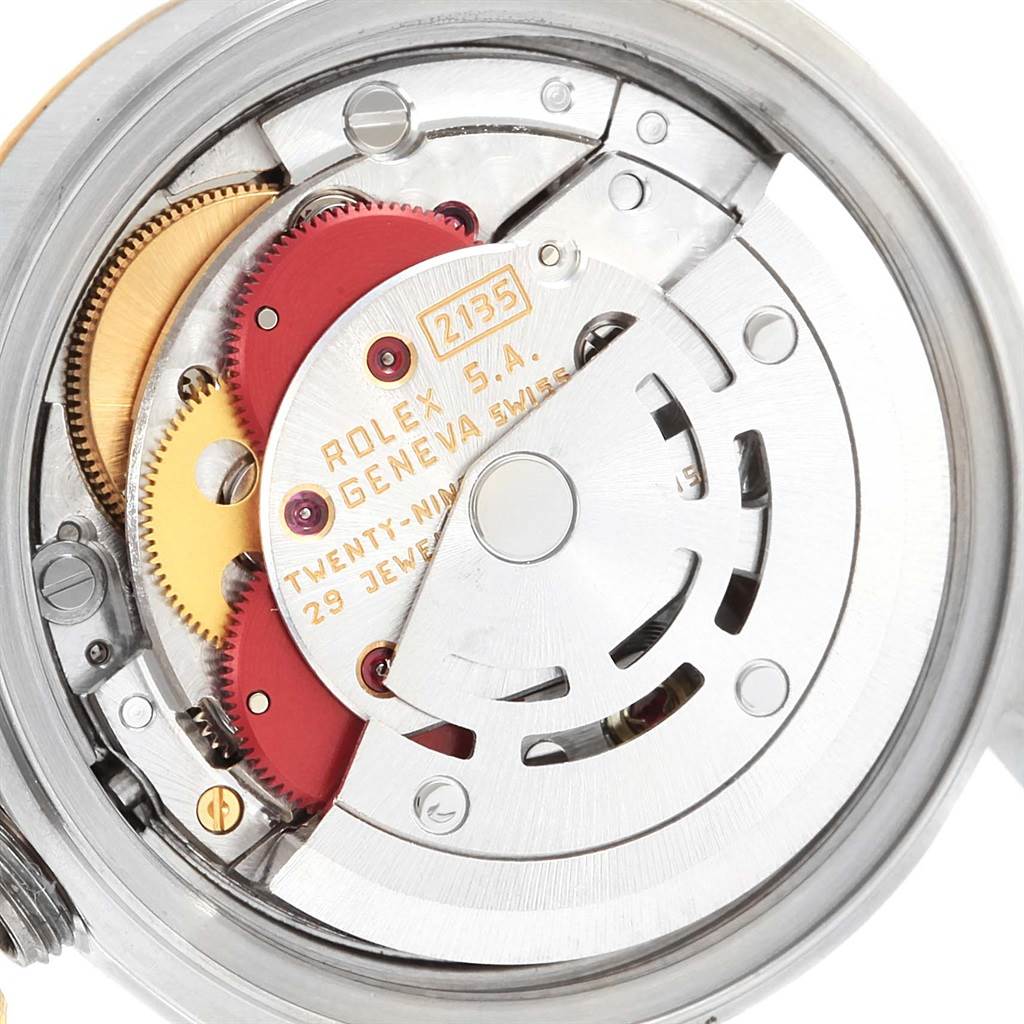 The image shows the inner mechanism of a Rolex Datejust 69173 Women's Stainless Steel Blue Dial 69173 Women's Stainless Steel Blue Dial watch, highlighting gears, jewels, and the rotor from the back.