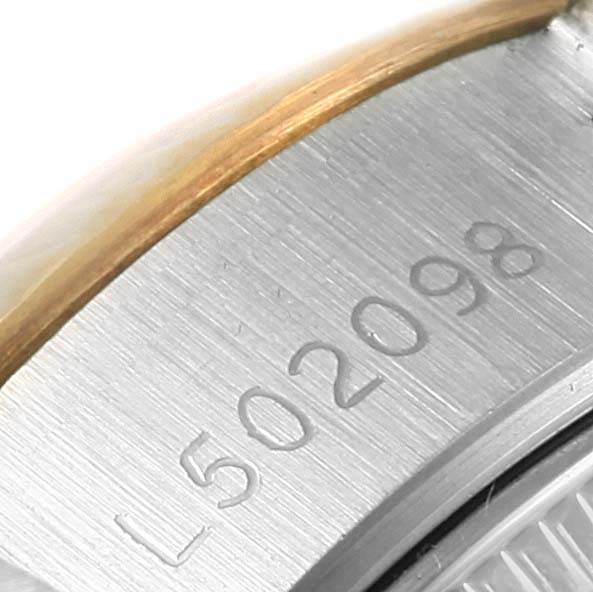 This close-up image of a Rolex Datejust 69173 Women's Stainless Steel Blue Dial 69173 Women's Stainless Steel Blue Dial watch shows part of the case and the engraved serial number on the side.
