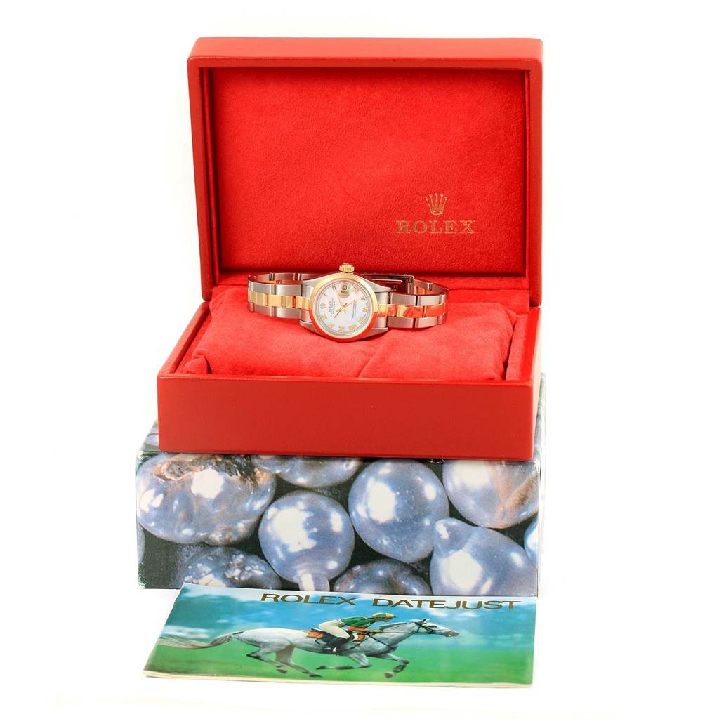 The Rolex Datejust 69163 Women's Stainless Steel Mother of Pearl Dial 69163 Women's Stainless Steel Mother of Pearl Dial watch is shown in an open red box, displaying the watch face and band, with a brochure beside it.