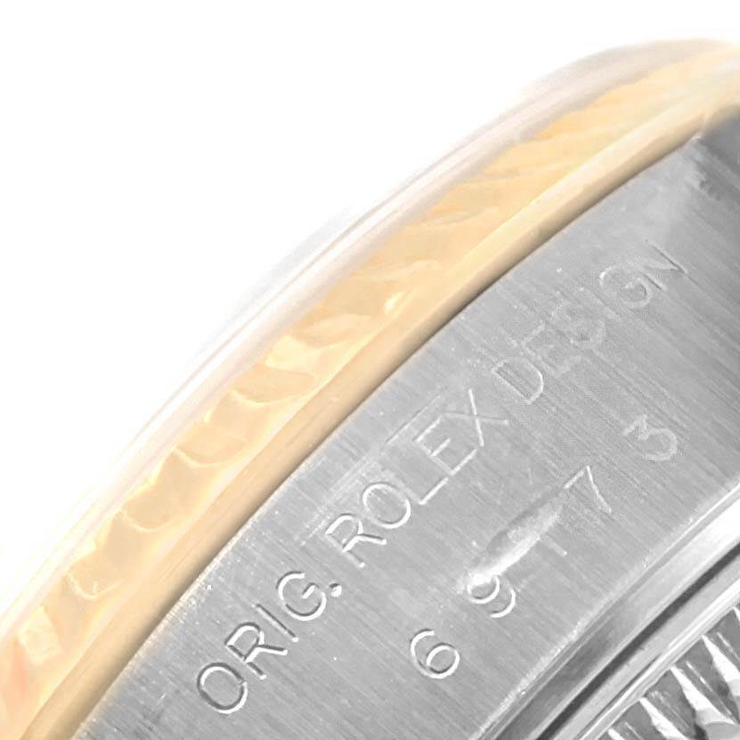 This image shows a close-up of the side of a Rolex Datejust 69173 Women's Stainless Steel Champagne Dial 69173 Women's Stainless Steel Champagne Dial watch bezel, displaying the engraved text "ORIG. ROLEX DESIGN."