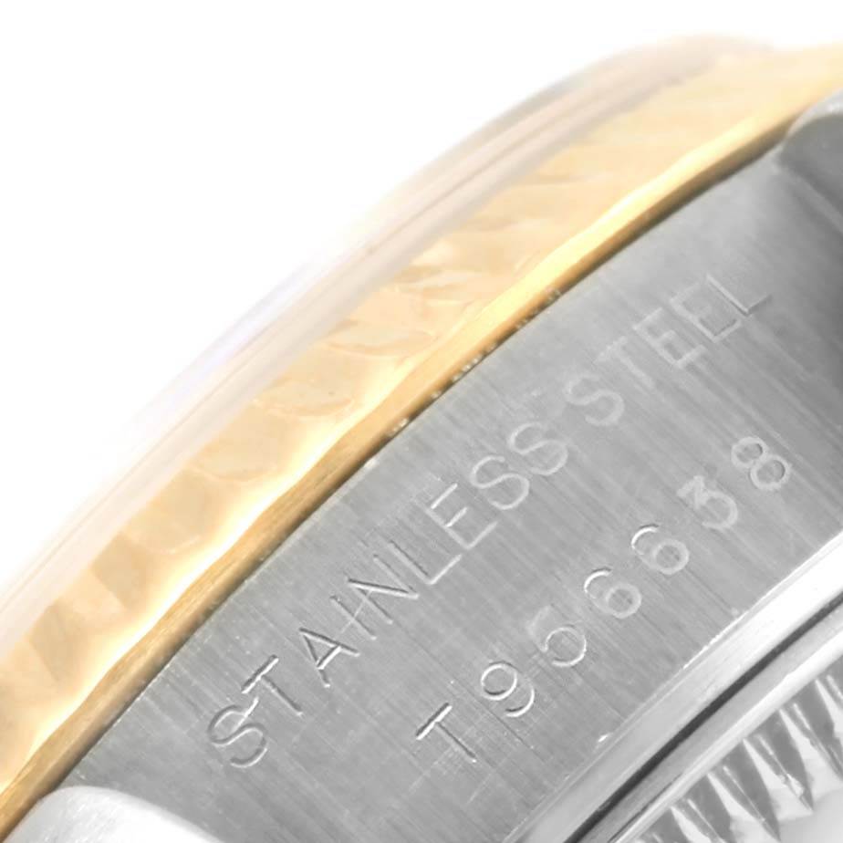 This close-up image shows the side of the bezel and part of the case with engraved text on a Rolex Datejust 69173 Women's Stainless Steel Champagne Dial 69173 Women's Stainless Steel Champagne Dial watch.