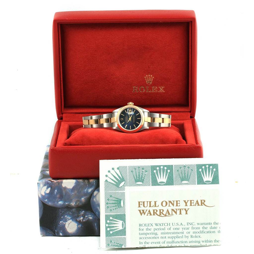 The Rolex Datejust 69163 Women's Stainless Steel Blue Dial 69163 Women's Stainless Steel Blue Dial watch is displayed front-facing in an open red box, with its warranty card in front of it.