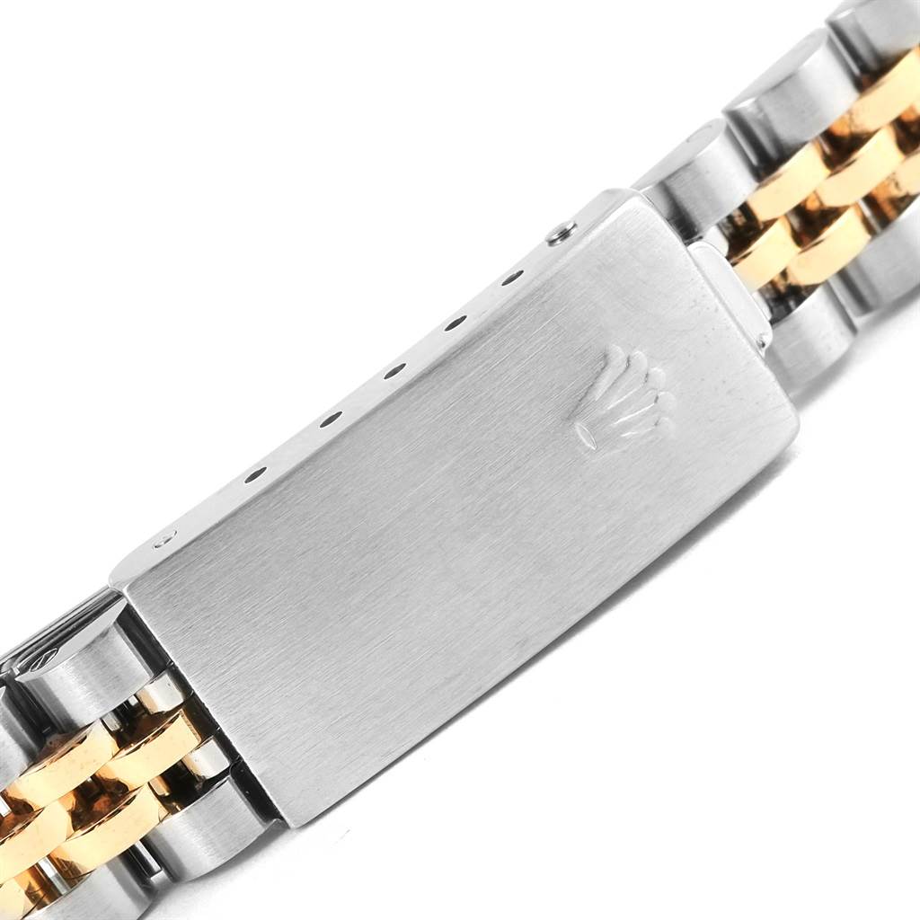This image shows a close-up of the clasp on a Rolex Datejust 69173 Women's Stainless Steel Champagne Dial 69173 Women's Stainless Steel Champagne Dial watch bracelet, highlighting its two-tone metal finish.