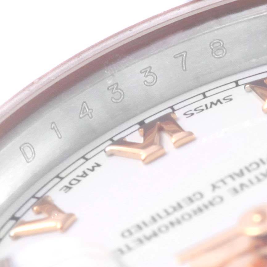 The image shows a close-up view of the serial number and partial dial of a Rolex Datejust 179161 Women's Steel and Gold (two tone) White Dial 179161 Women's Steel and Gold (two tone) White Dial watch.