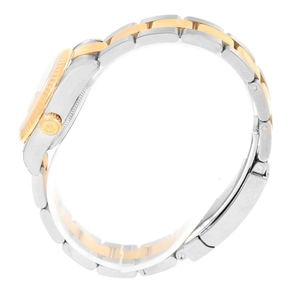 This side-angle image of a Rolex Datejust 179173 Women's Steel and Gold (two tone) Champagne Dial 179173 Women's Steel and Gold (two tone) Champagne Dial watch shows the clasp, band, crown, and part of the case.