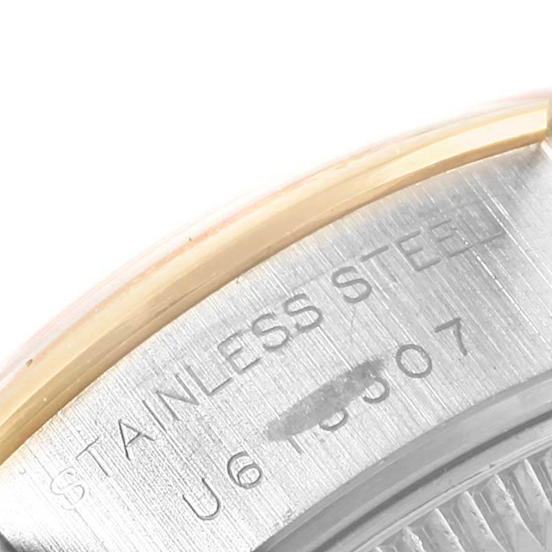 The image shows a close-up of the case back edge of a Rolex Datejust 69163 Women's Stainless Steel Grey Dial 69163 Women's Stainless Steel Grey Dial, highlighting the stainless steel and serial number details.