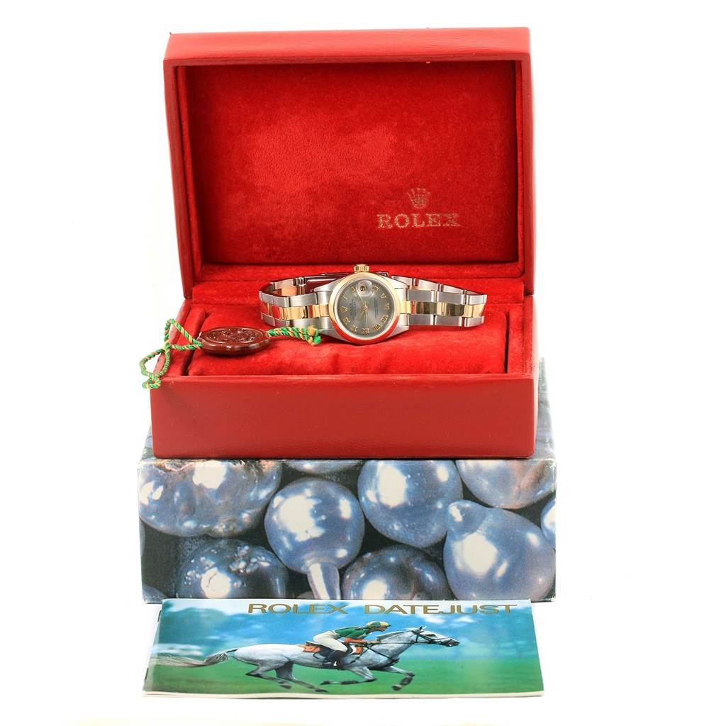 The image shows a Rolex Datejust 69163 Women's Stainless Steel Grey Dial 69163 Women's Stainless Steel Grey Dial watch at eye level in an open red box, with a tag and booklet.
