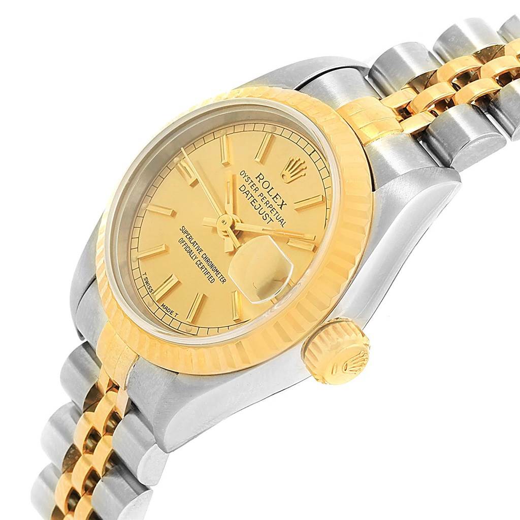 The Rolex Datejust 69173 Women's Stainless Steel Champagne Dial 69173 Women's Stainless Steel Champagne Dial watch is displayed at an angle, showing its yellow gold bezel, dial, and two-tone bracelet.