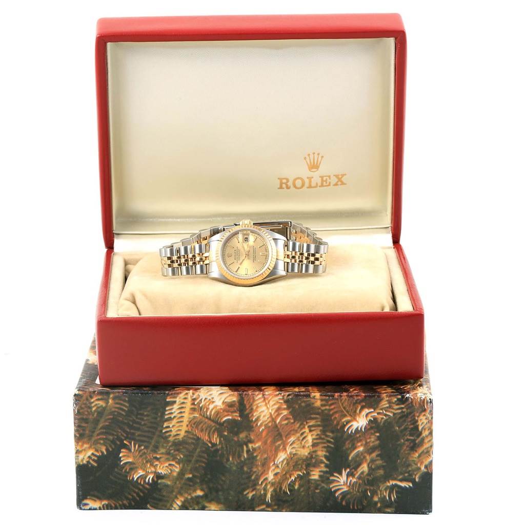 A Rolex Datejust 69173 Women's Stainless Steel Champagne Dial 69173 Women's Stainless Steel Champagne Dial watch is shown from the front, nestled in its open red box.