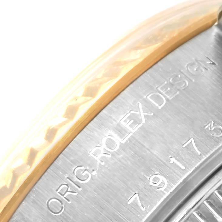 This image shows a close-up of the bezel and case back engraving of a Rolex Datejust 79173 Women's Steel and Gold (two tone) Champagne Dial 79173 Women's Steel and Gold (two tone) Champagne Dial watch.