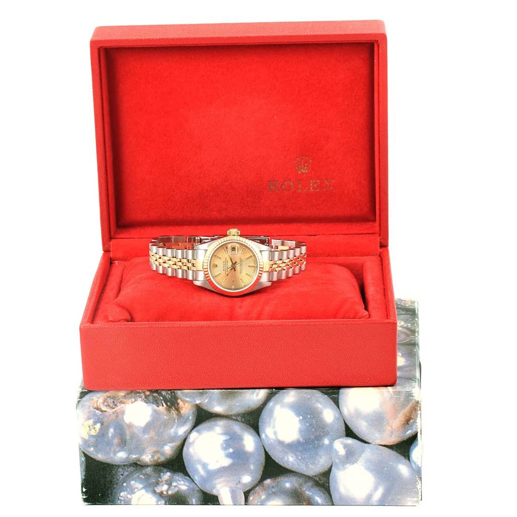 The Rolex Datejust 79173 Women's Steel and Gold (two tone) Champagne Dial 79173 Women's Steel and Gold (two tone) Champagne Dial watch is displayed directly from the front inside a red Rolex-branded box.