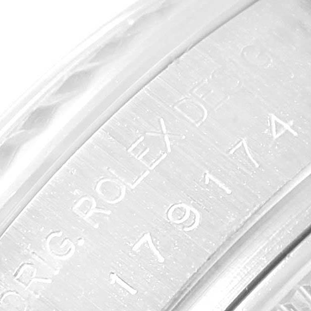 This close-up image shows the engraved inner bezel and fluted bezel details of a Rolex Datejust 179174 Women
s Stainless Steel Mother of Pearl Dial 179174 Women
s Stainless Steel Mother of Pearl Dial watch.