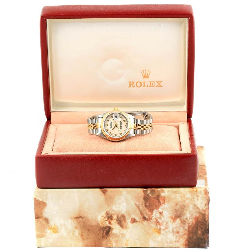 The Rolex Datejust 79173 Women's Steel and Gold (two tone) Beige Dial 79173 Women's Steel and Gold (two tone) Beige Dial watch is shown from a frontal angle inside its branded presentation box.