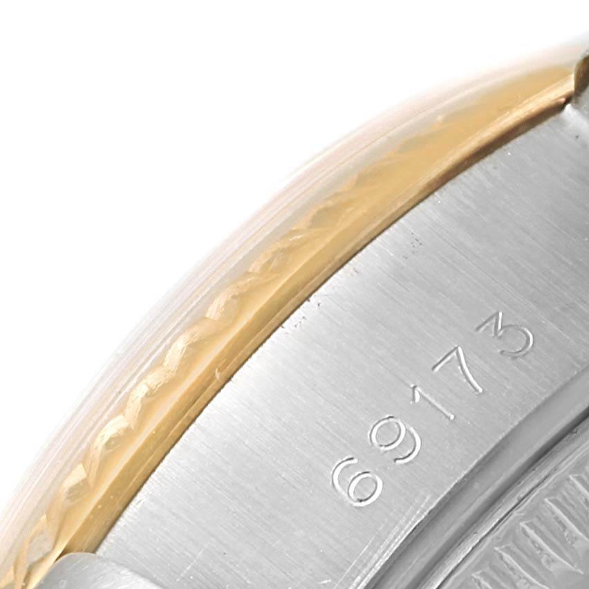 This close-up angle of the Rolex Datejust 69173 Women's Stainless Steel Silver Dial 69173 Women's Stainless Steel Silver Dial watch shows part of the case with the model number 69173 engraved.