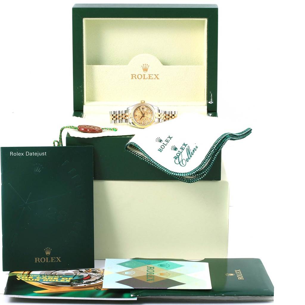 The image shows the Rolex Datejust 179173 Women's Steel and Gold (two tone) Champagne Dial 179173 Women's Steel and Gold (two tone) Champagne Dial watch with its box, manuals, tag, and polishing cloth from a front angle.