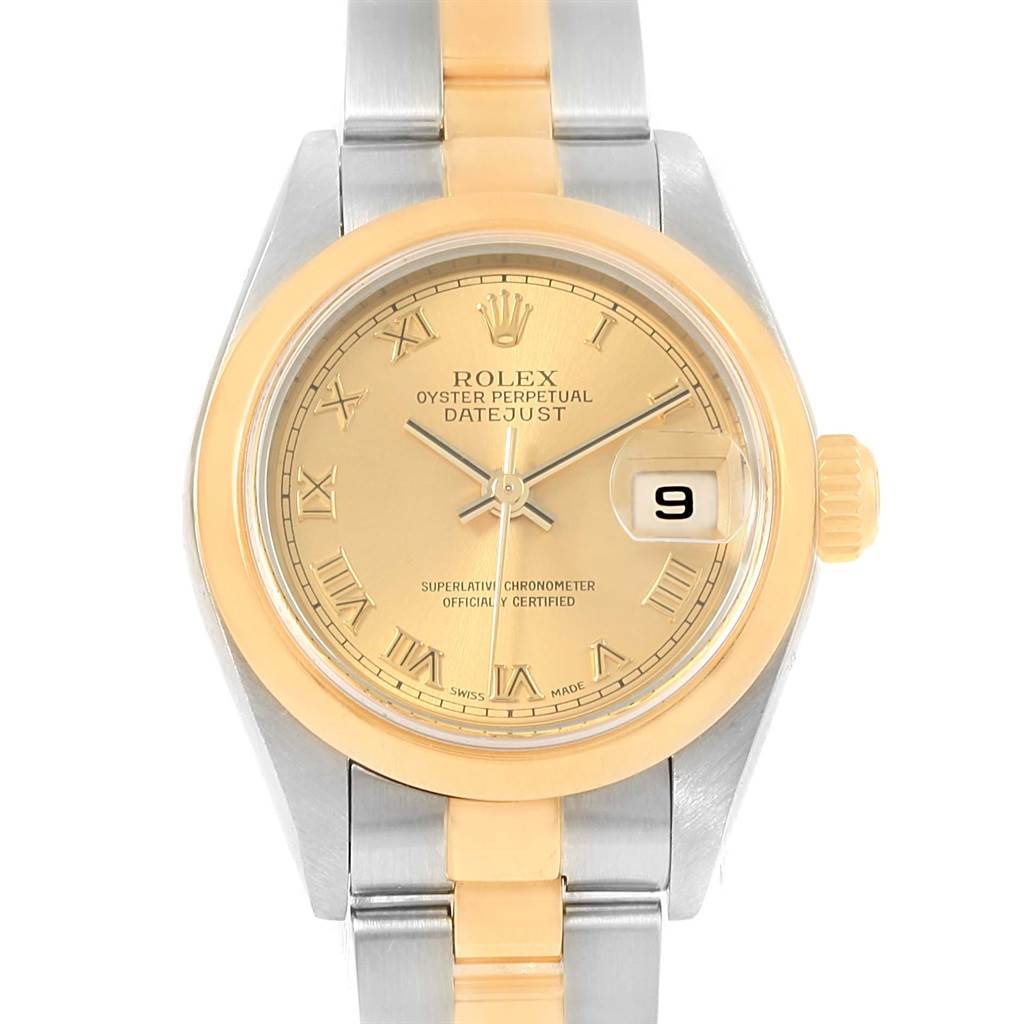 The image shows a front view of a Rolex Datejust 79163 Women's Steel and Gold (two tone) Champagne Dial 79163 Women's Steel and Gold (two tone) Champagne Dial watch, highlighting its gold dial, bezel, Roman numerals, and two-tone bracelet.