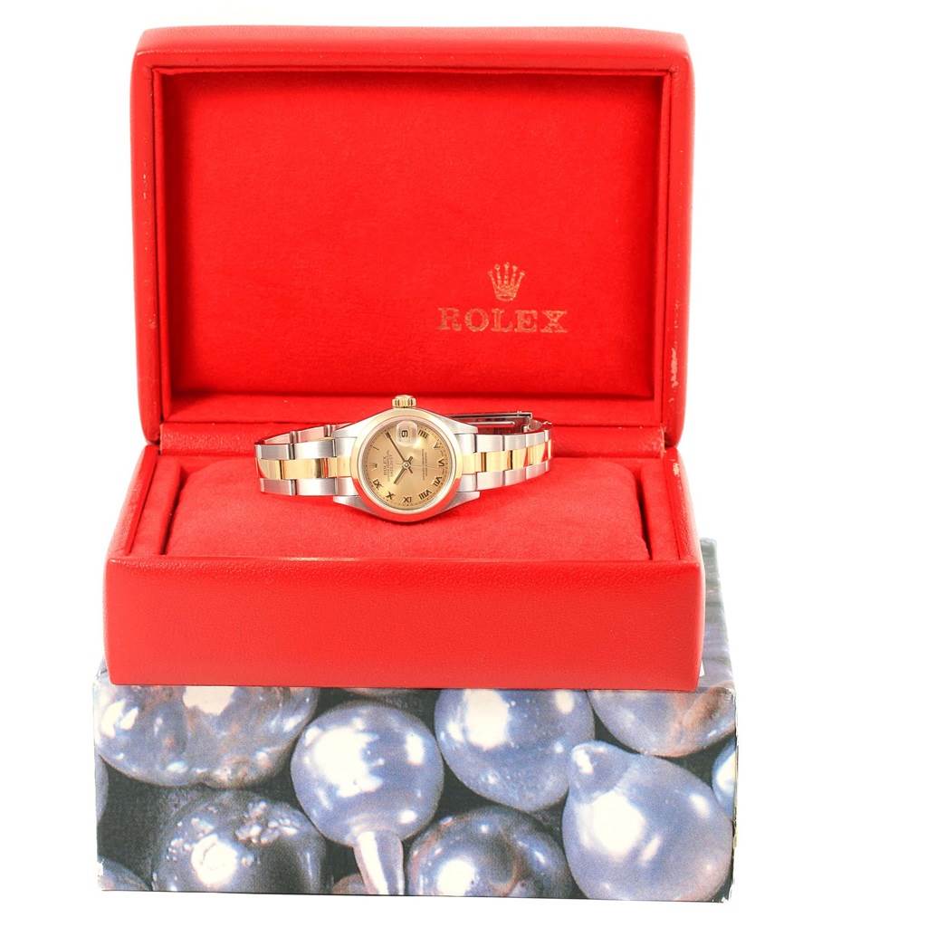 The Rolex Datejust 79163 Women's Steel and Gold (two tone) Champagne Dial 79163 Women's Steel and Gold (two tone) Champagne Dial watch is displayed front-on in an open red box, showing the dial, bezel, and bracelet.