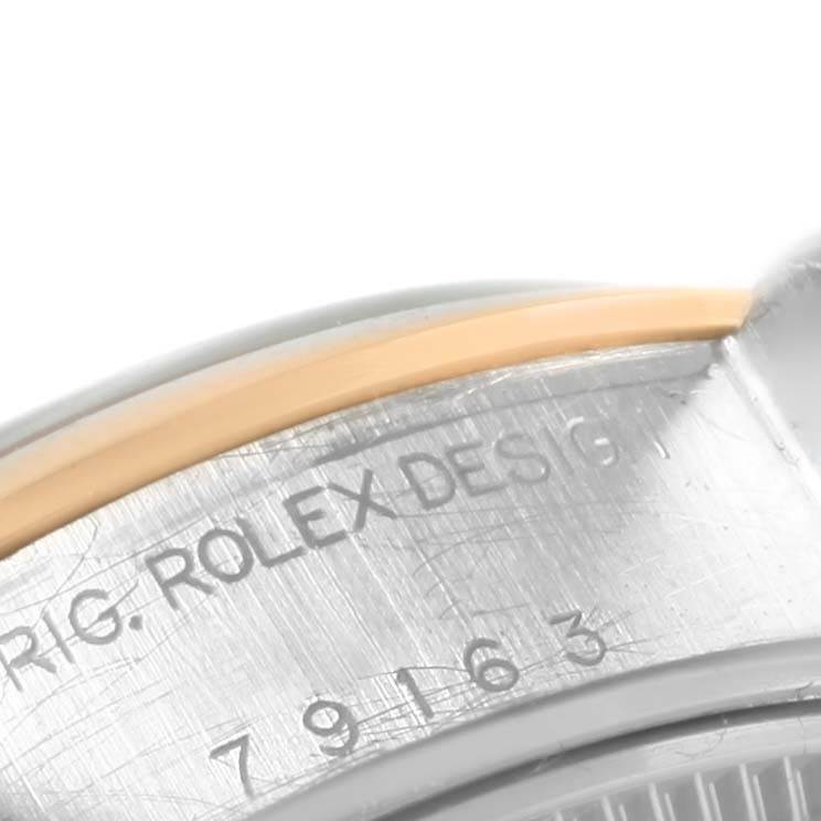 This close-up angle shows part of the bezel and case area of the Rolex Datejust 79163 Women's Steel and Gold (two tone) Champagne Dial 79163 Women's Steel and Gold (two tone) Champagne Dial with visible engravings.