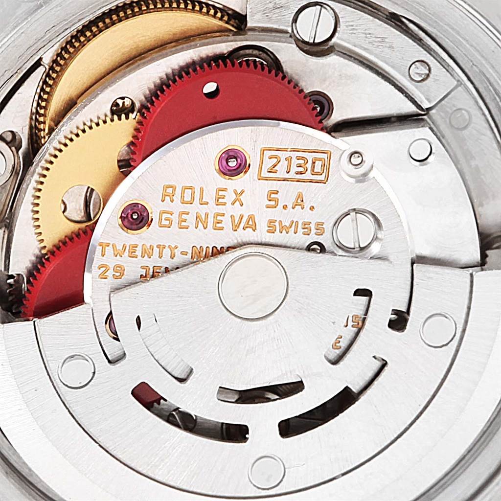 This image shows an internal view of the Rolex Datejust 69173 Women's Stainless Steel Champagne Dial 69173 Women's Stainless Steel Champagne Dial movement mechanism, highlighting the gears and engravings.