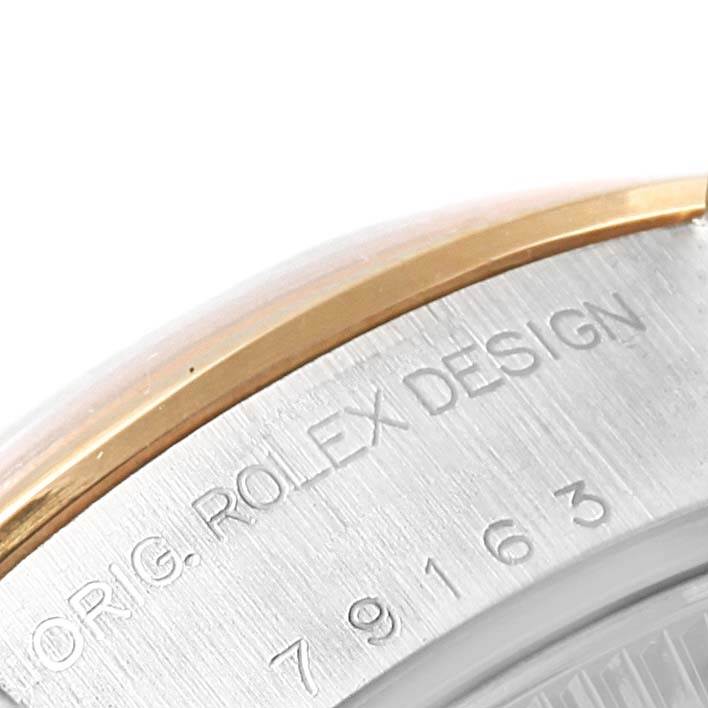 The image shows an angled close-up of the side of a Rolex Datejust 79163 Women's Steel and Gold (two tone) Silver Dial 79163 Women's Steel and Gold (two tone) Silver Dial watch, highlighting the "ROLEX DESIGN" engraving and part of the bezel.