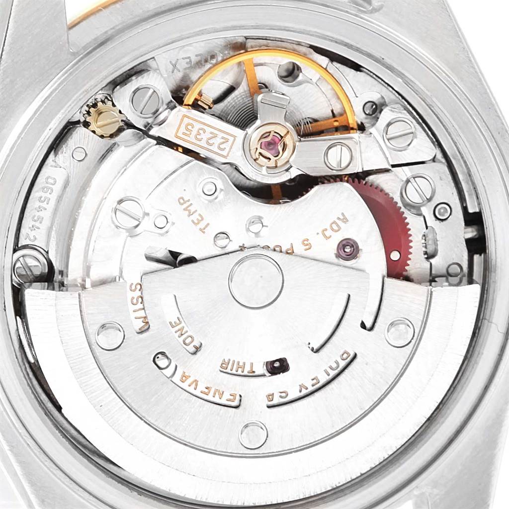 This close-up image of a Rolex Datejust 79163 Women's Steel and Gold (two tone) Silver Dial 79163 Women's Steel and Gold (two tone) Silver Dial watch shows the intricate details of its movement mechanism.