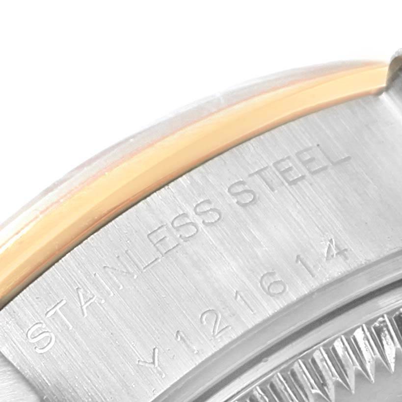 The image shows a close-up of the side of a Rolex Datejust 79163 Women's Steel and Gold (two tone) Silver Dial 79163 Women's Steel and Gold (two tone) Silver Dial's stainless steel case and part of its bezel.