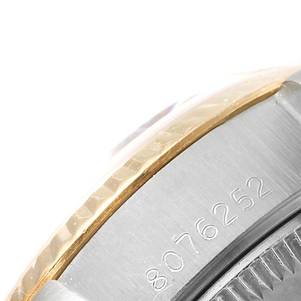 This image shows a close-up of the case side and bezel area of a Rolex Datejust 69173 Women's Stainless Steel White Dial 69173 Women's Stainless Steel White Dial watch, highlighting part of the serial number.