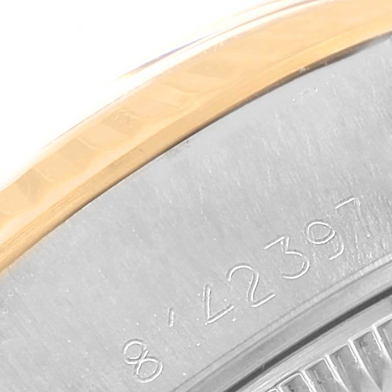 This close-up image of the Rolex Datejust 69173 Women's Stainless Steel Silver Dial 69173 Women's Stainless Steel Silver Dial watch shows part of its engraved bezel and casing.