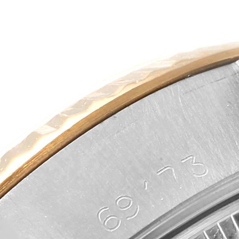 The image shows a close-up of the edge of the bezel and part of the case back of a Rolex Datejust 69173 Women's Stainless Steel Silver Dial 69173 Women's Stainless Steel Silver Dial watch.