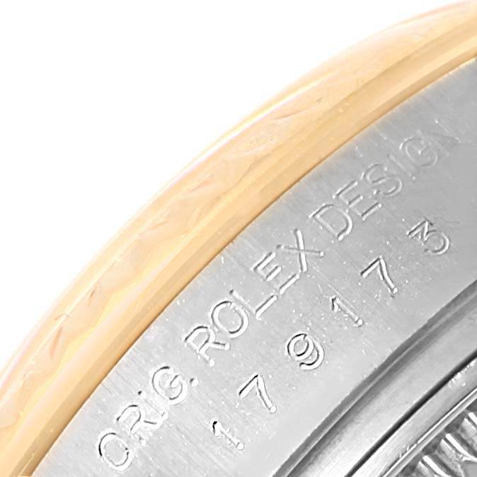 This close-up shows the side engraving on the bezel of a Rolex Datejust 179173 Women's Steel and Gold (two tone) Black Dial 179173 Women's Steel and Gold (two tone) Black Dial watch.