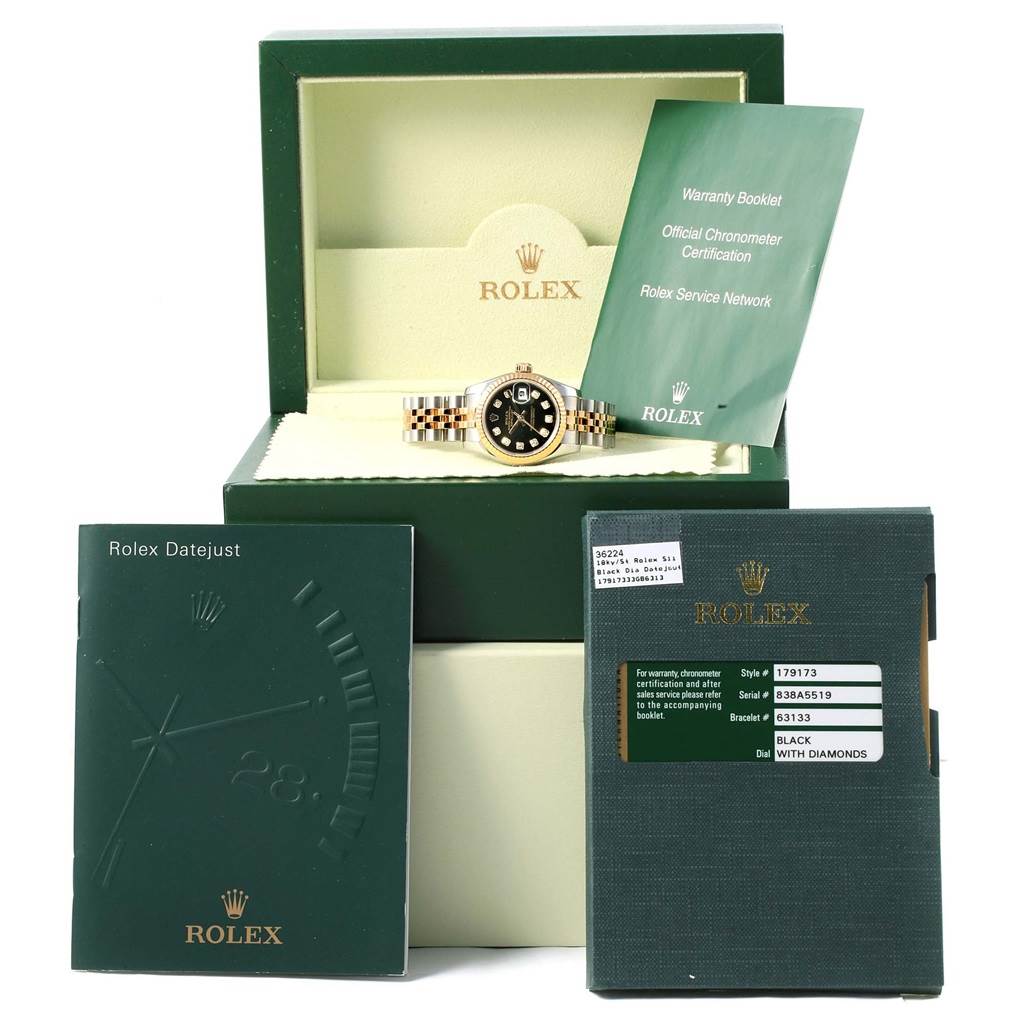 The image shows a Rolex Datejust 179173 Women's Steel and Gold (two tone) Black Dial 179173 Women's Steel and Gold (two tone) Black Dial watch in its box, along with warranty booklets and a service manual.