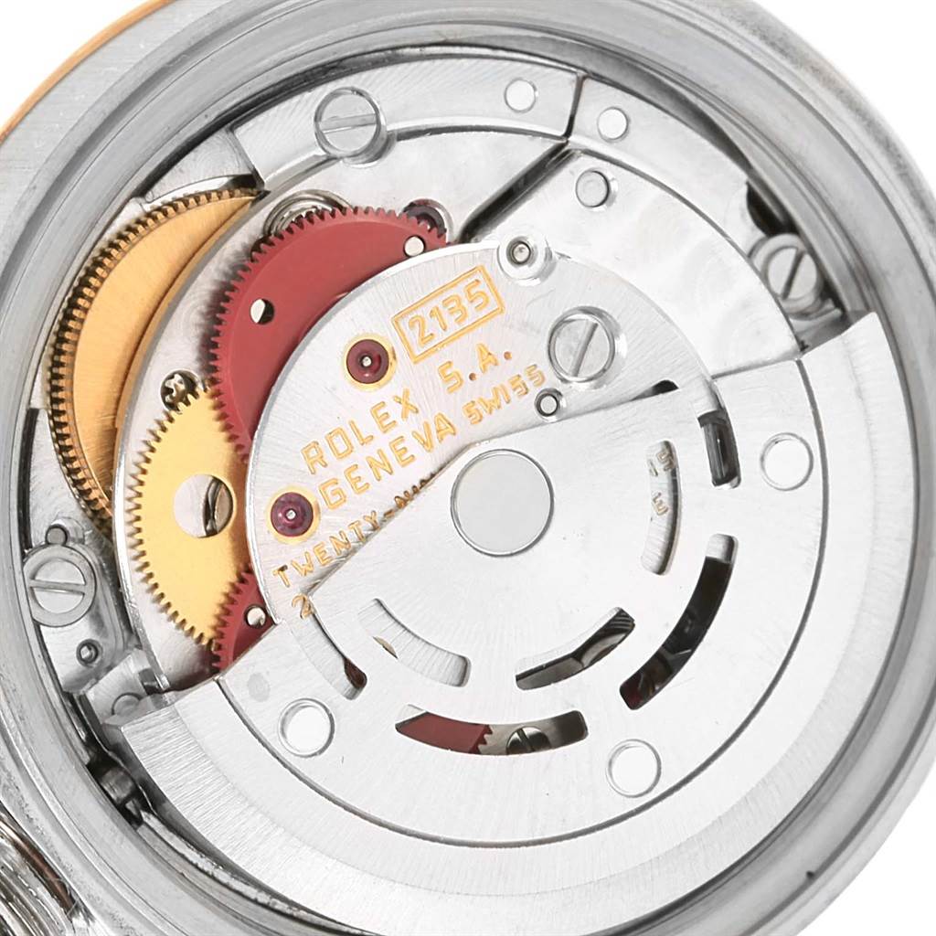 The image shows the movement mechanism of a Rolex Datejust 69173 Women's Stainless Steel White Dial 69173 Women's Stainless Steel White Dial watch, highlighting gears and inscriptions.