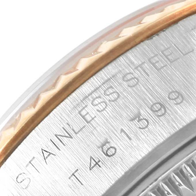 A close-up view of the side of the bezel and case of a Rolex Datejust 69173 Women's Stainless Steel Silver Dial 69173 Women's Stainless Steel Silver Dial, showing the stainless steel and inscription.