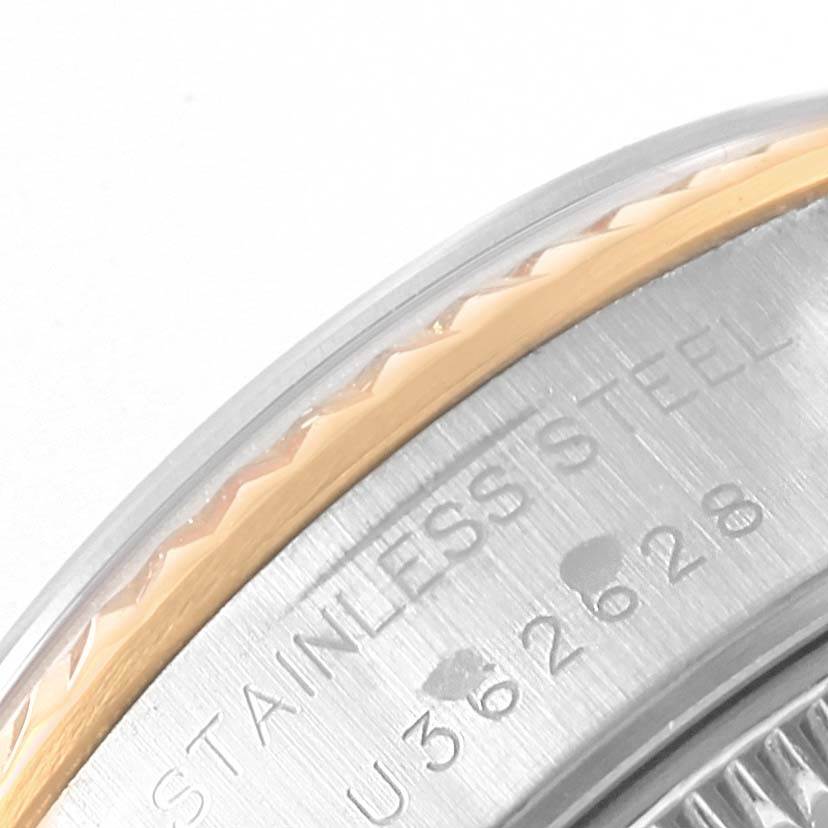 Close-up of the stainless steel case and bezel edge of a Rolex Datejust 69173 Women's Stainless Steel Blue Dial 69173 Women's Stainless Steel Blue Dial watch, showing part of the engraved serial number.