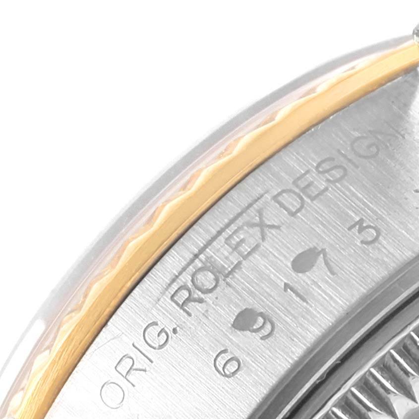 This image shows a close-up of the side bezel and part of the dial inscription of a Rolex Datejust 69173 Women's Stainless Steel Blue Dial 69173 Women's Stainless Steel Blue Dial watch.