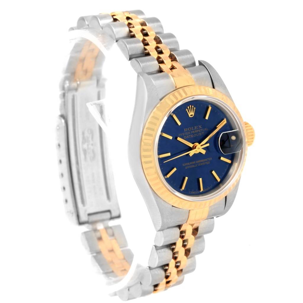 The image shows a Rolex Datejust 69173 Women's Stainless Steel Blue Dial 69173 Women's Stainless Steel Blue Dial model watch at an angled view, highlighting its blue dial, two-tone bracelet, and fluted bezel.