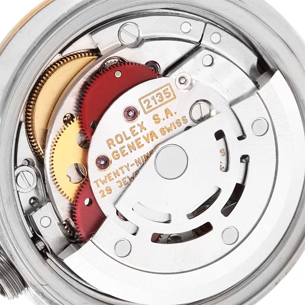 This is a close-up view of the internal mechanism of the Rolex Datejust 69173 Women's Stainless Steel Blue Dial 69173 Women's Stainless Steel Blue Dial model watch, showing gears and the rotor.