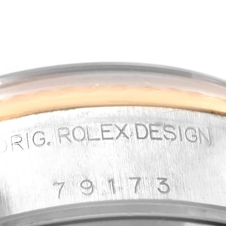 The image shows a close-up of the casing with "ORIG. ROLEX DESIGN" and the model number 79173 engraved on the Rolex Datejust 79173 Women's Steel and Gold (two tone) White Dial 79173 Women's Steel and Gold (two tone) White Dial watch.