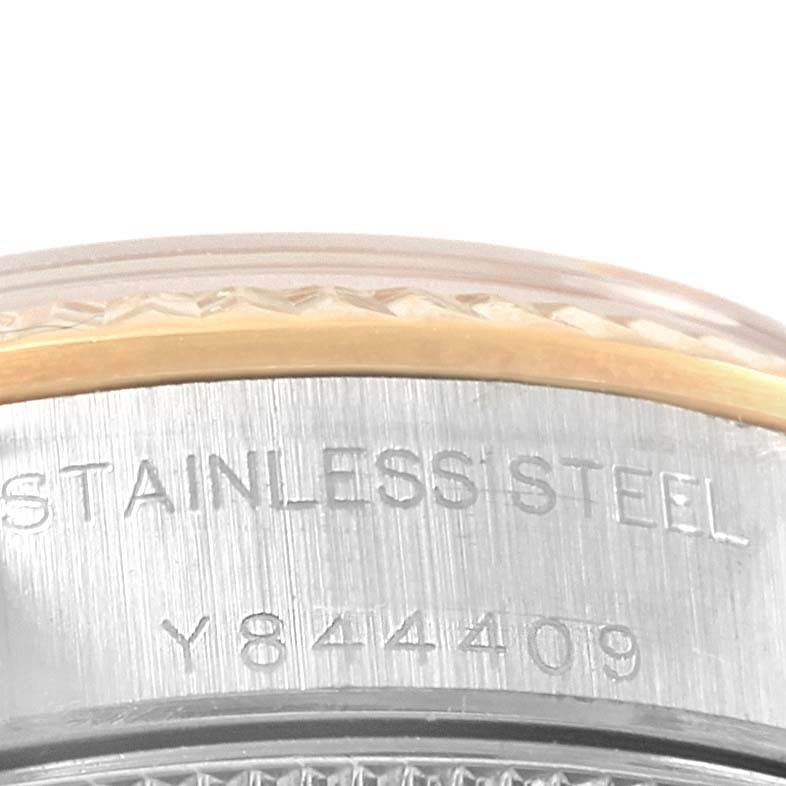 This close-up image shows the side of a Rolex Datejust 76193 Women's Steel and Gold (two tone) Blue Dial 76193 Women's Steel and Gold (two tone) Blue Dial watch, highlighting the stainless steel casing with engraved serial numbers.