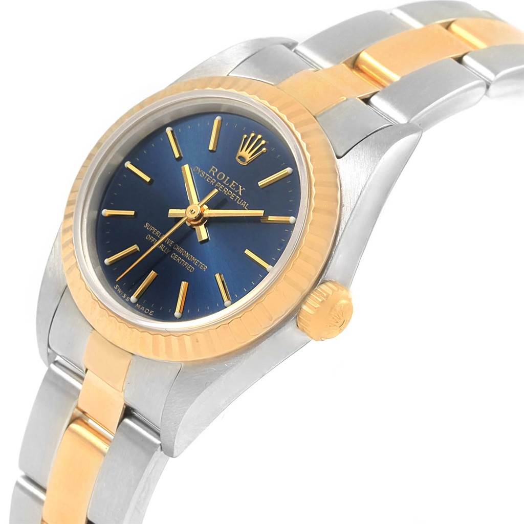 The Rolex Datejust 76193 Women's Steel and Gold (two tone) Blue Dial 76193 Women's Steel and Gold (two tone) Blue Dial model is shown at an angled close-up, highlighting its blue dial, gold bezel, two-tone bracelet, and crown.