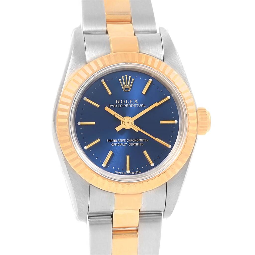 The image shows a frontal view of a Rolex Datejust 76193 Women's Steel and Gold (two tone) Blue Dial 76193 Women's Steel and Gold (two tone) Blue Dial watch, highlighting its blue dial, gold fluted bezel, and two-tone bracelet.