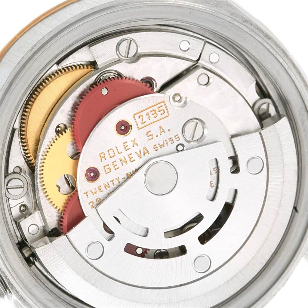 The image shows the internal mechanism of a Rolex Datejust 69173 Women's Stainless Steel Silver Dial 69173 Women's Stainless Steel Silver Dial model watch, focusing on gears and the rotor.