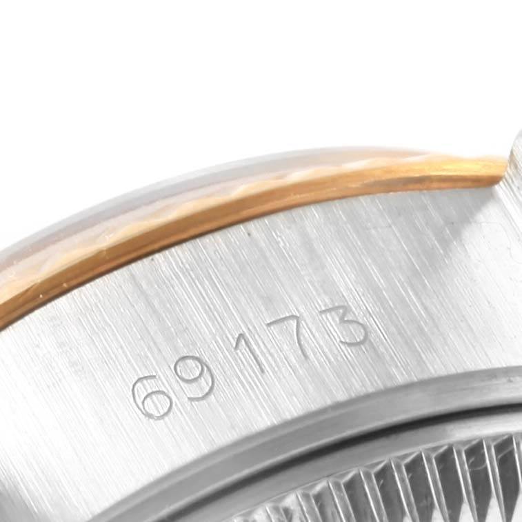 This close-up image of a Rolex Datejust 69173 Women's Stainless Steel Silver Dial 69173 Women's Stainless Steel Silver Dial shows the engraved model number and part of the bezel and case.
