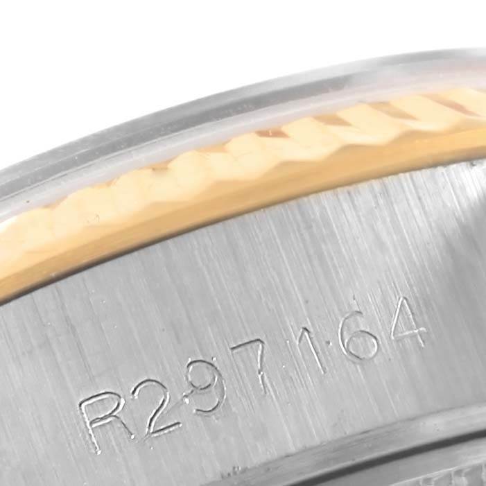 The image shows a close-up of the bezel and part of the case with serial number engraving of the Rolex Datejust 69173 Women's Stainless Steel Silver Dial 69173 Women's Stainless Steel Silver Dial model.