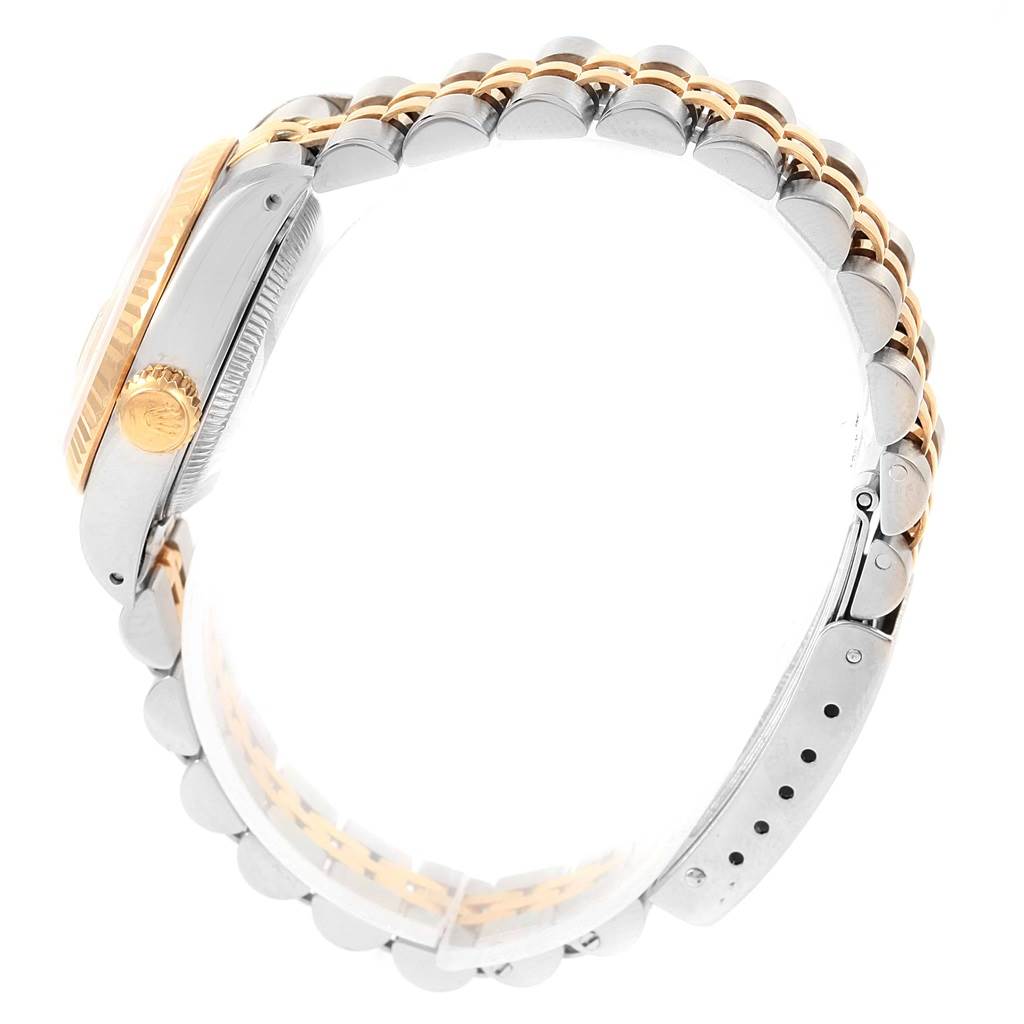 This image shows a side view of a Rolex Datejust 69173 Women's Stainless Steel Champagne Dial 69173 Women's Stainless Steel Champagne Dial watch, highlighting the crown, fluted bezel, and bicolor bracelet.